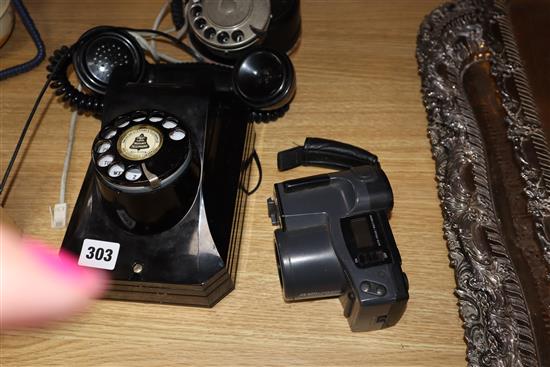 An American rotary wall phone, another and an Olympus camera